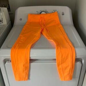ALO orange leggings with drawstring waistline and side pockets. Size S. $60 OBO
